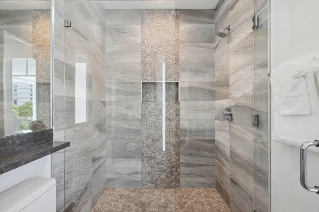a living room with furniture a chandelier and a flat screen tv