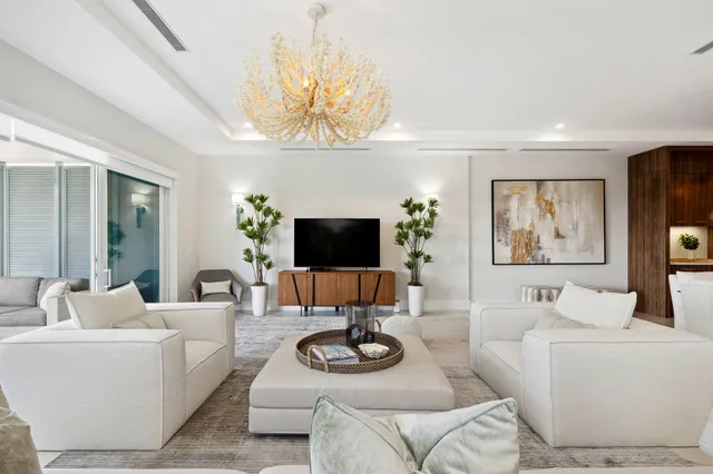 a view of staircase with lots of frames on wall and a window