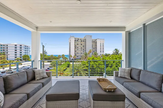 a living room with furniture a table and a potted plant