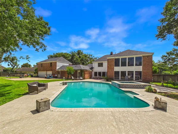 a front view of a house with swimming pool having outdoor seating
