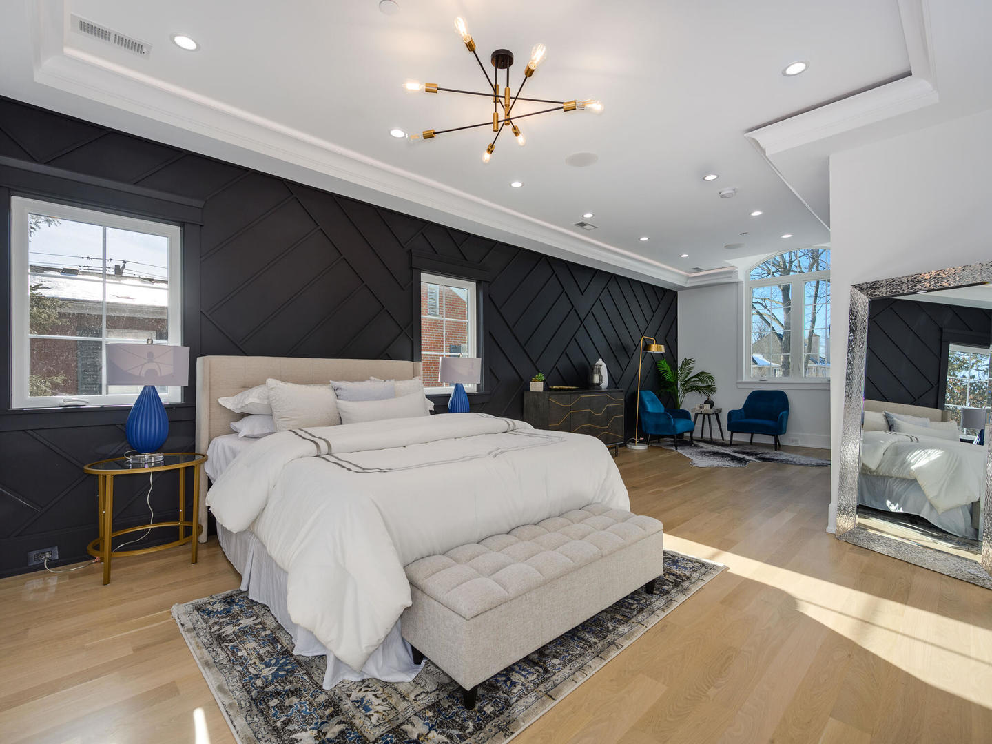 1115 South Delphia Avenue Park Ridge, IL 60068 - Photo 27 of 38 a spacious bedroom with a large bed and a chandelier