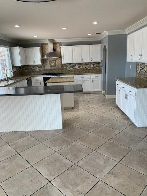 6148 Cecina Place Palmdale, CA 93552 - Photo 19 of 66 a kitchen with stainless steel appliances granite countertop a stove a sink and a microwave