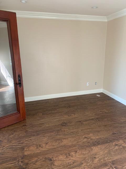 6148 Cecina Place Palmdale, CA 93552 - Photo 30 of 66 a view of an empty room with wooden floor and a window
