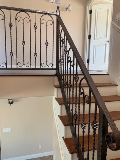 6148 Cecina Place Palmdale, CA 93552 - Photo 35 of 66 a view of staircase with lots of frames on wall and a window