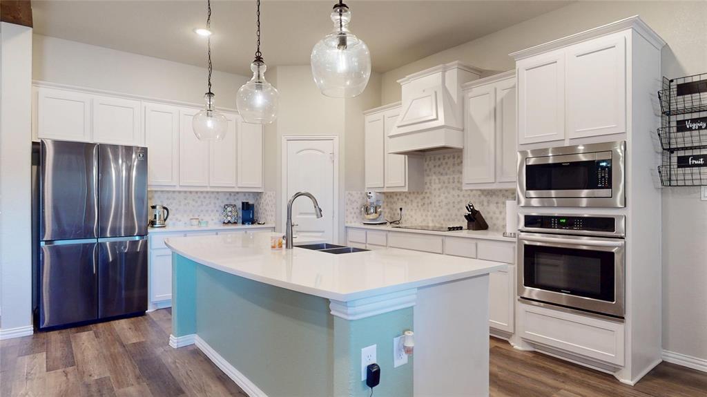 1037 Boulder Road Weatherford, TX 76085 - Photo 11 of 24 a kitchen with stainless steel appliances a stove a sink and a refrigerator