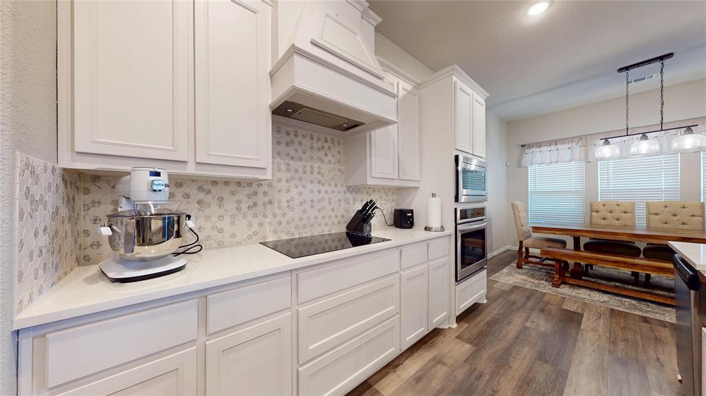 1037 Boulder Road Weatherford, TX 76085 - Photo 12 of 24 a kitchen with white cabinets and window