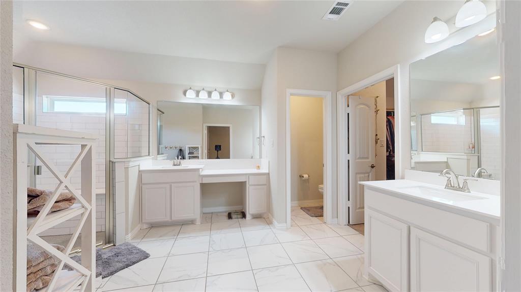 1037 Boulder Road Weatherford, TX 76085 - Photo 15 of 24 a bathroom with a sink a mirror and a shower