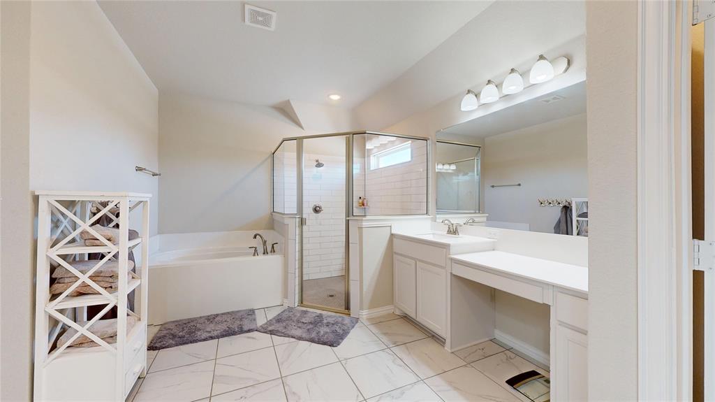 1037 Boulder Road Weatherford, TX 76085 - Photo 16 of 24 a spacious bathroom with a bathtub sink and a mirror