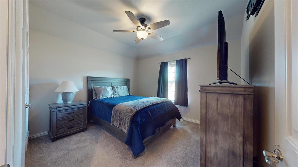 1037 Boulder Road Weatherford, TX 76085 - Photo 20 of 24 a bedroom with a bed and a chandelier