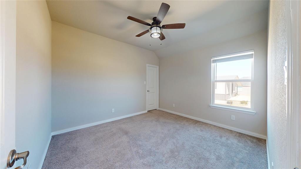 1037 Boulder Road Weatherford, TX 76085 - Photo 22 of 24 an empty room with a window and a fan