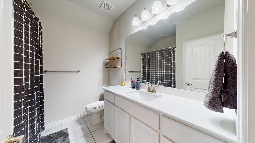 1037 Boulder Road Weatherford, TX 76085 - Photo 23 of 24 a bathroom with a sink a toilet and shower