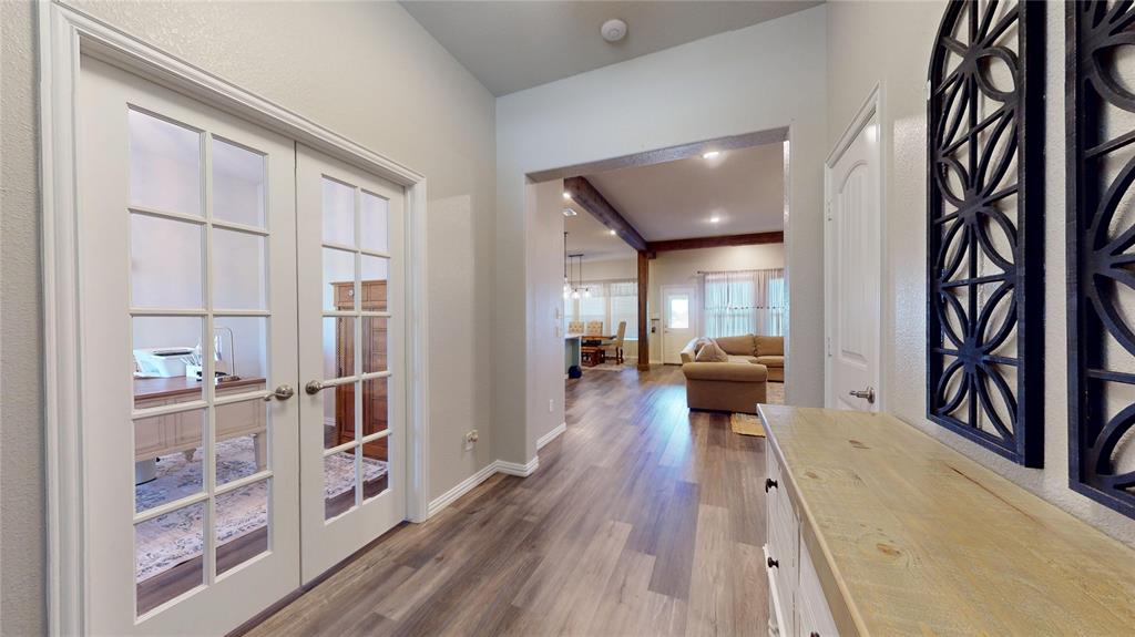 1037 Boulder Road Weatherford, TX 76085 - Photo 5 of 24 a view of a hallway with wooden floor and staircase