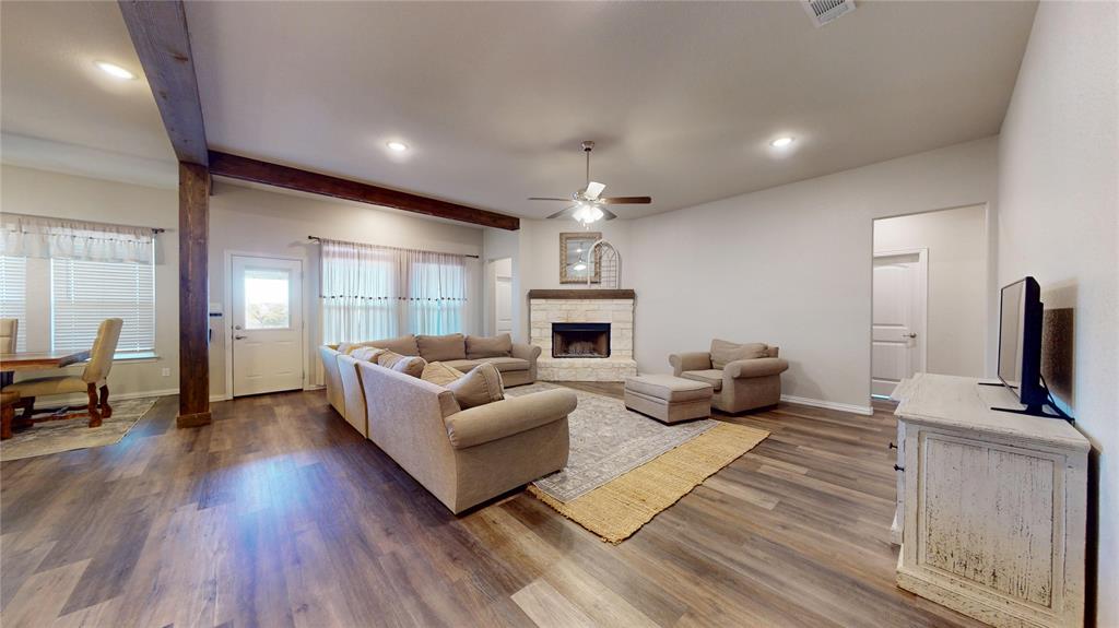1037 Boulder Road Weatherford, TX 76085 - Photo 6 of 24 a living room with furniture fireplace and flat screen tv