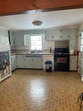 a kitchen with stainless steel appliances a stove and a sink