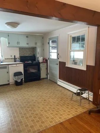 a kitchen with a stove a refrigerator and a sink