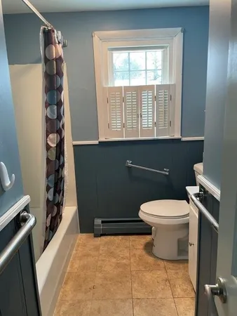 a bathroom with a toilet and a shower