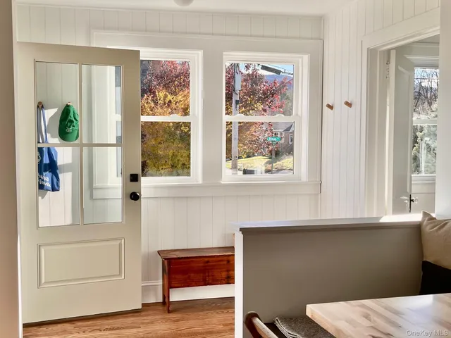 a view of a bedroom with wooden floor and a window
