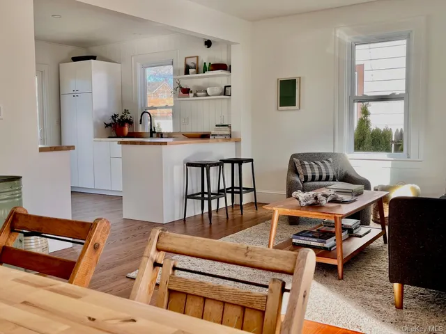 a living room with furniture fireplace and a window