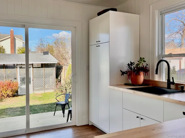 a bathroom with a tub and a large window