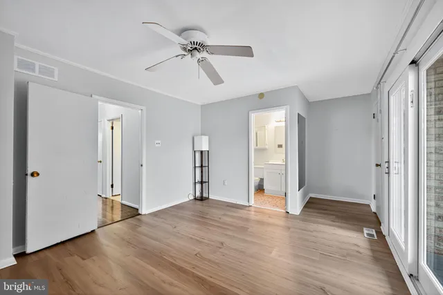 a view of an empty room with wooden floor
