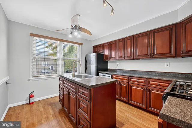 a kitchen with a stove a sink dishwasher and a microwave oven with cabinets
