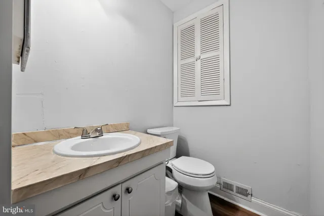 a bathroom with a sink toilet and mirror