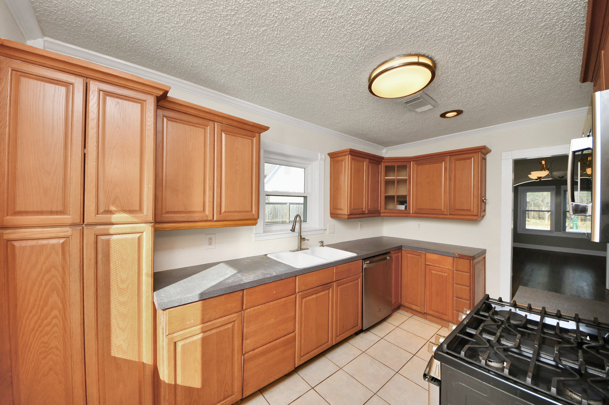 516 Eleanor Street Houston, TX 77009 - Photo 11 of 25 Kitchen with gas cooking, tile floors, and ample countertop space.