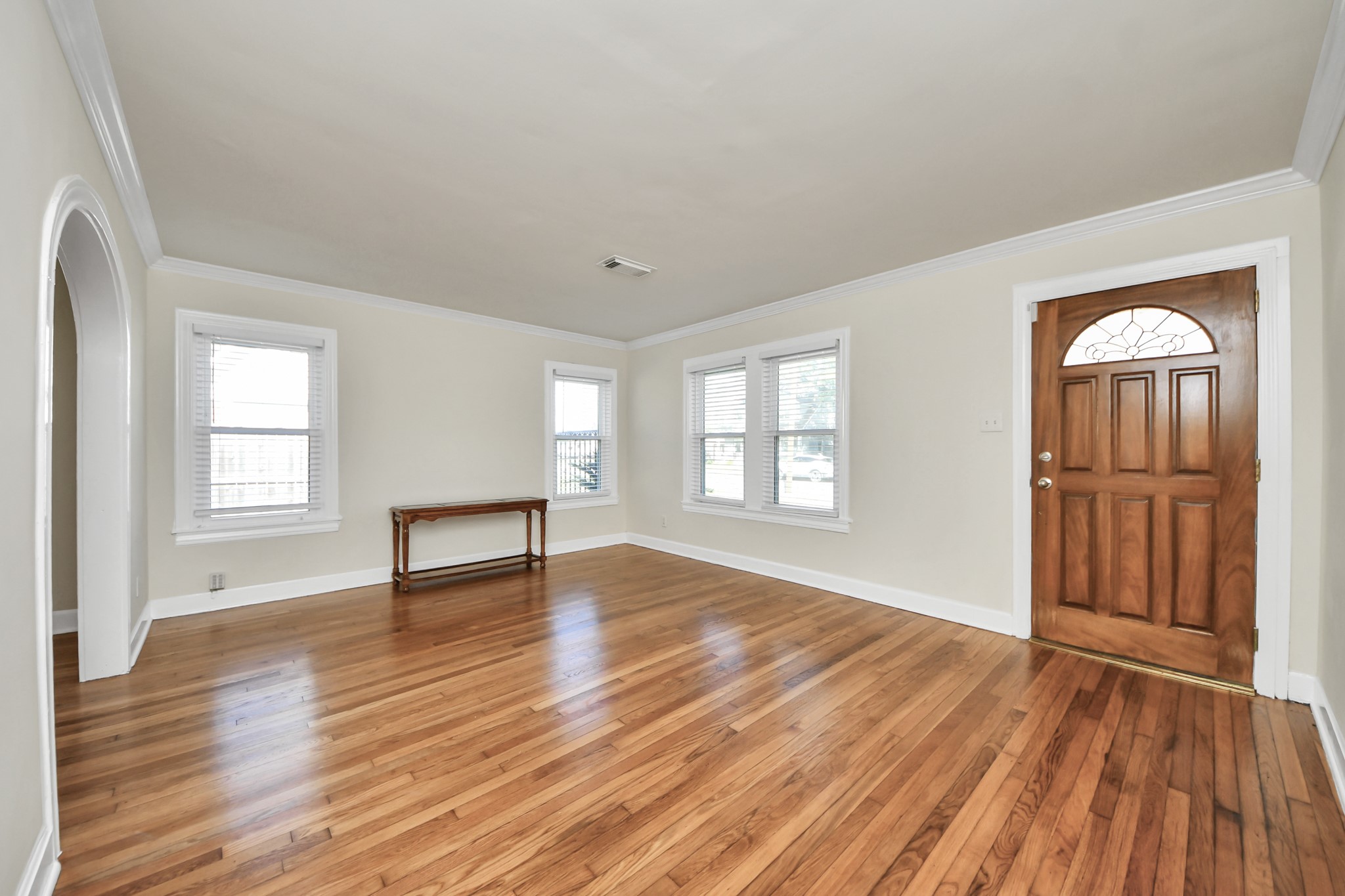 516 Eleanor Street Houston, TX 77009 - Photo 5 of 25 Spacious family room featuring wood floors, neutral paint tones, and a large window that fills the space with natural light.
