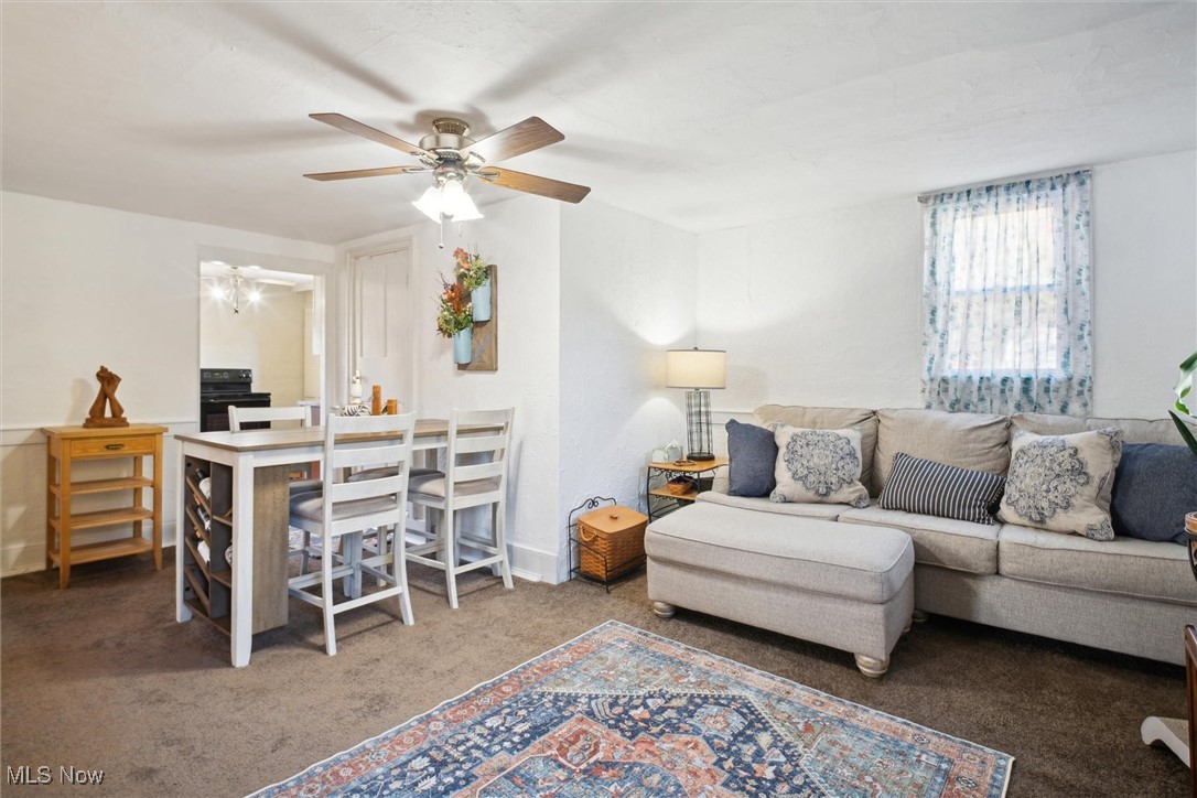 13930 Carter Road Wakeman, OH 44889 - Photo 21 of 45 Carpeted living room with ceiling fan