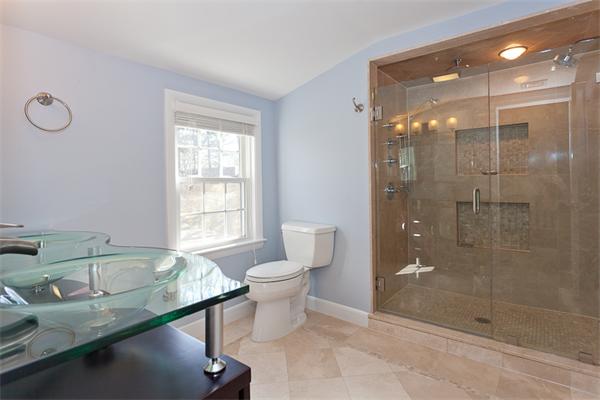 231 Ridge Street Arlington, MA 02474 - Photo 15 of 22 a bathroom with a granite countertop sink a toilet and shower
