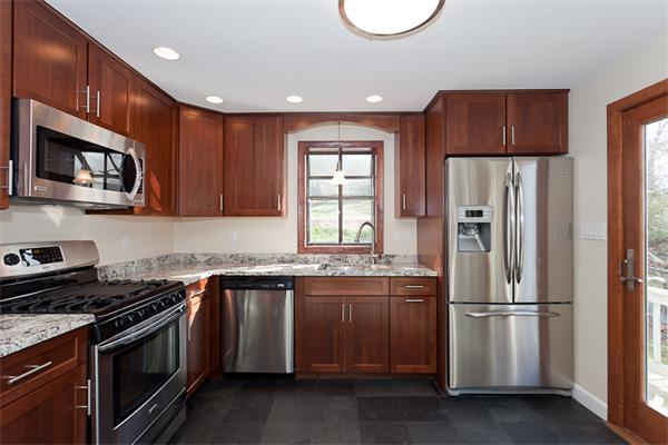 231 Ridge Street Arlington, MA 02474 - Photo 8 of 22 a kitchen with stainless steel appliances granite countertop a stove a refrigerator and a microwave