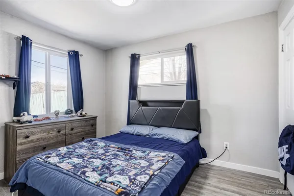 a bed sitting in a bedroom next to a window