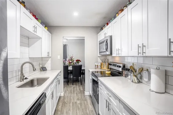 a kitchen with a sink stove and cabinets