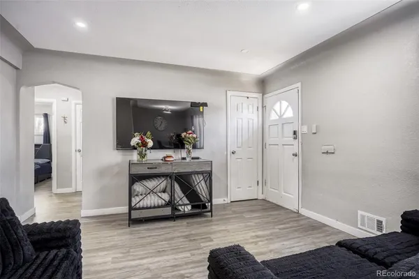 a view of room with furniture and wooden floor