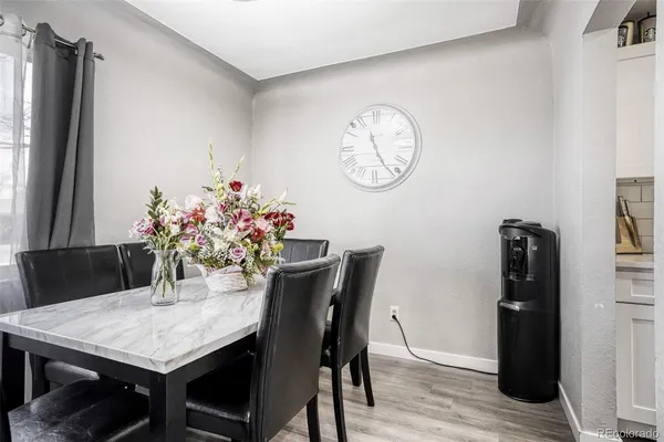 a dining room with furniture and wooden floor