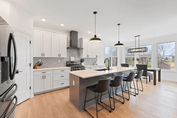 a open kitchen with stainless steel appliances granite countertop a sink stove and wooden floor