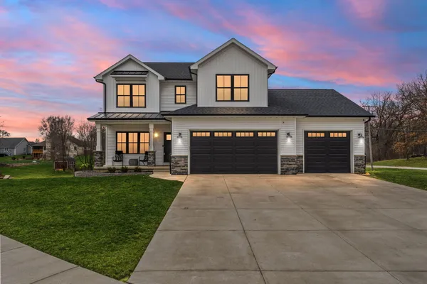 a front view of a house with a yard and garage