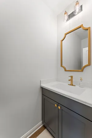 a bathroom with a sink vanity and a mirror