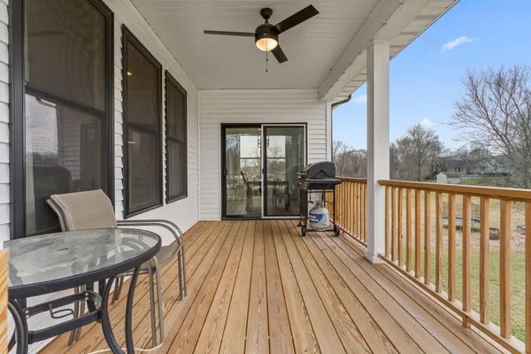 a view of balcony with wooden floor and outdoor seating