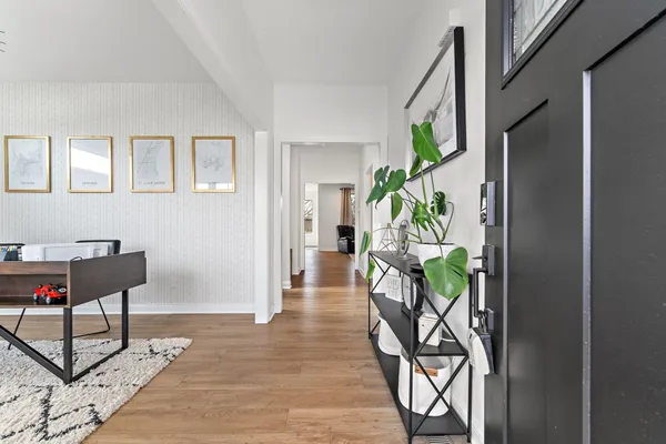 a living room with furniture and a potted plant