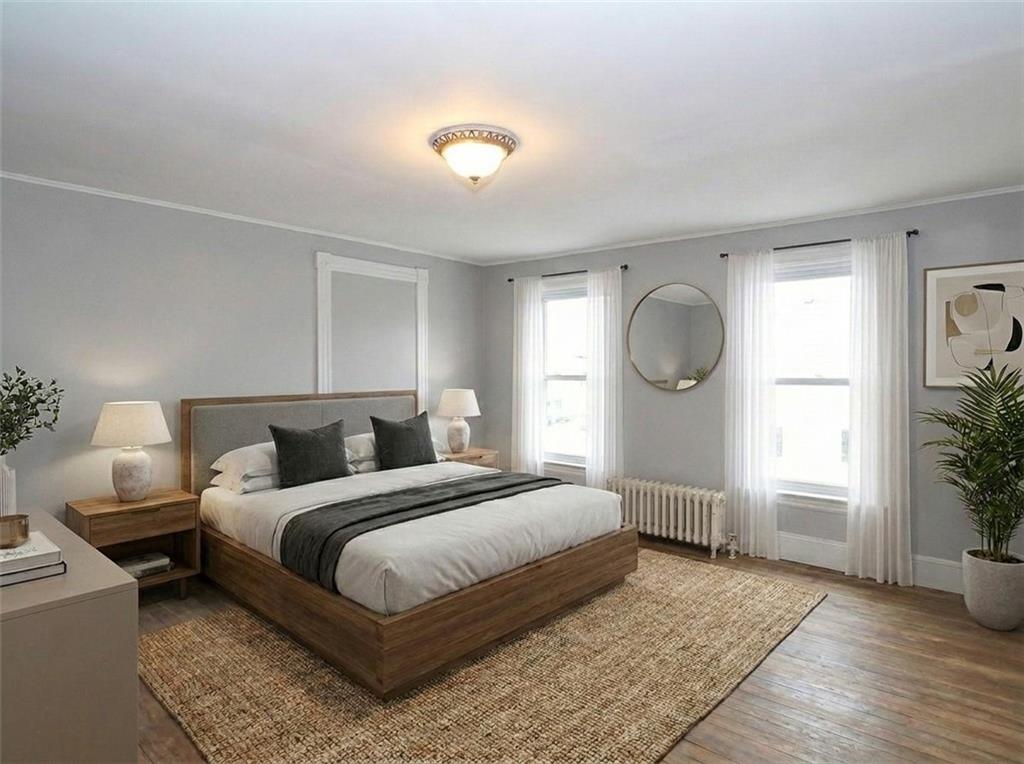 636 Holmdel Road Hazlet, NJ 07730 - Photo 25 of 47 a bedroom with a bed a mirror and a potted plant
