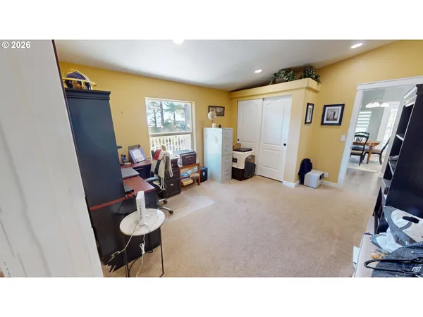 a living room with furniture a flat screen tv and a window
