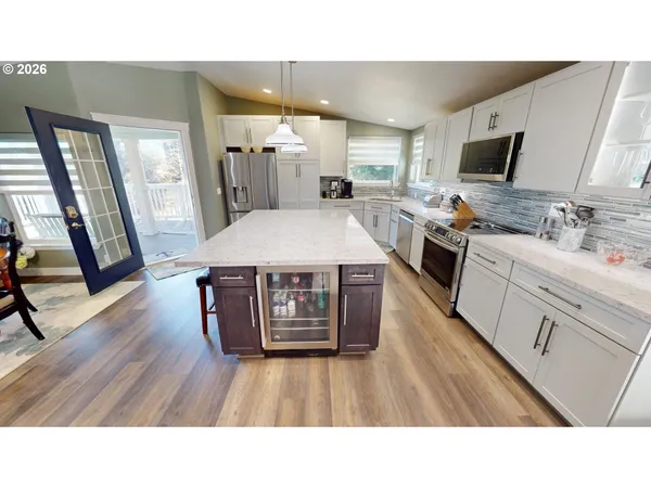 a open kitchen with sink stove microwave and wooden floor