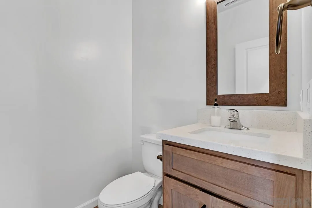 130 Scenic Drive El Cajon, CA 92021 - Photo 17 of 50 a bathroom with a granite countertop toilet sink and mirror