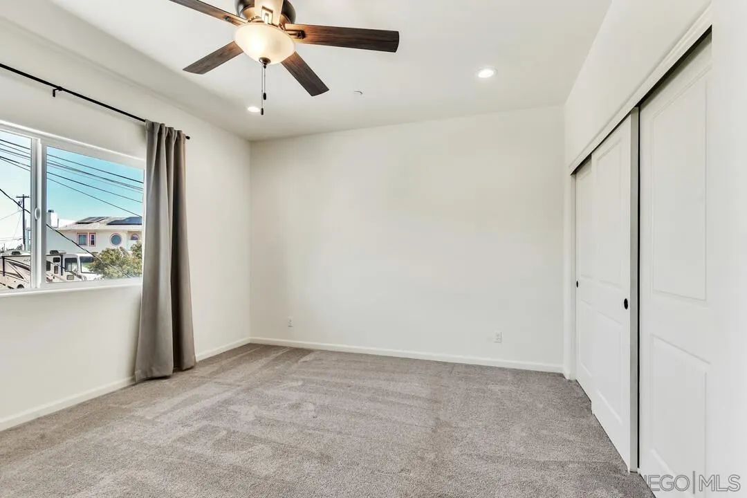 130 Scenic Drive El Cajon, CA 92021 - Photo 21 of 50 a view of a hallway with a chandelier fan and windows