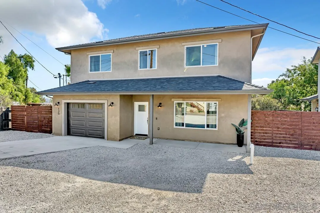 130 Scenic Drive El Cajon, CA 92021 - Photo 40 of 50 a front view of a house with a yard and garage