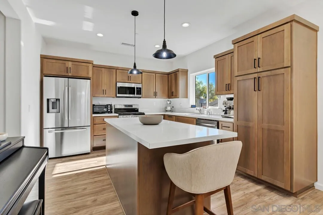 130 Scenic Drive El Cajon, CA 92021 - Photo 4 of 50 a kitchen with refrigerator cabinets and wooden floor