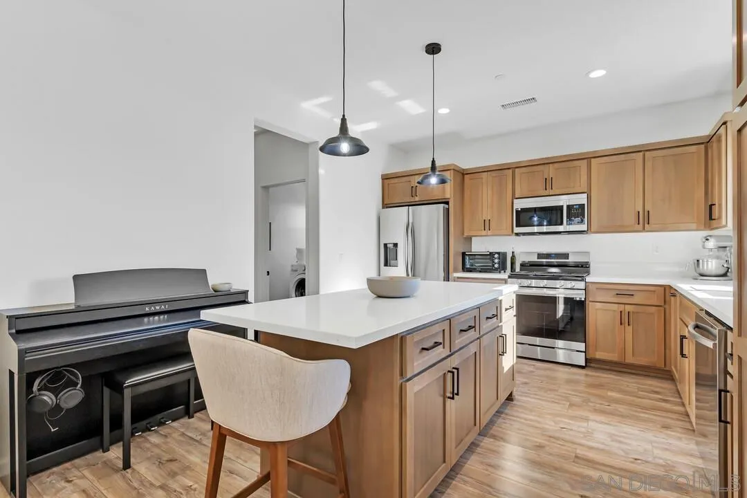 130 Scenic Drive El Cajon, CA 92021 - Photo 6 of 50 a kitchen with kitchen island a stove a sink island and a refrigerator