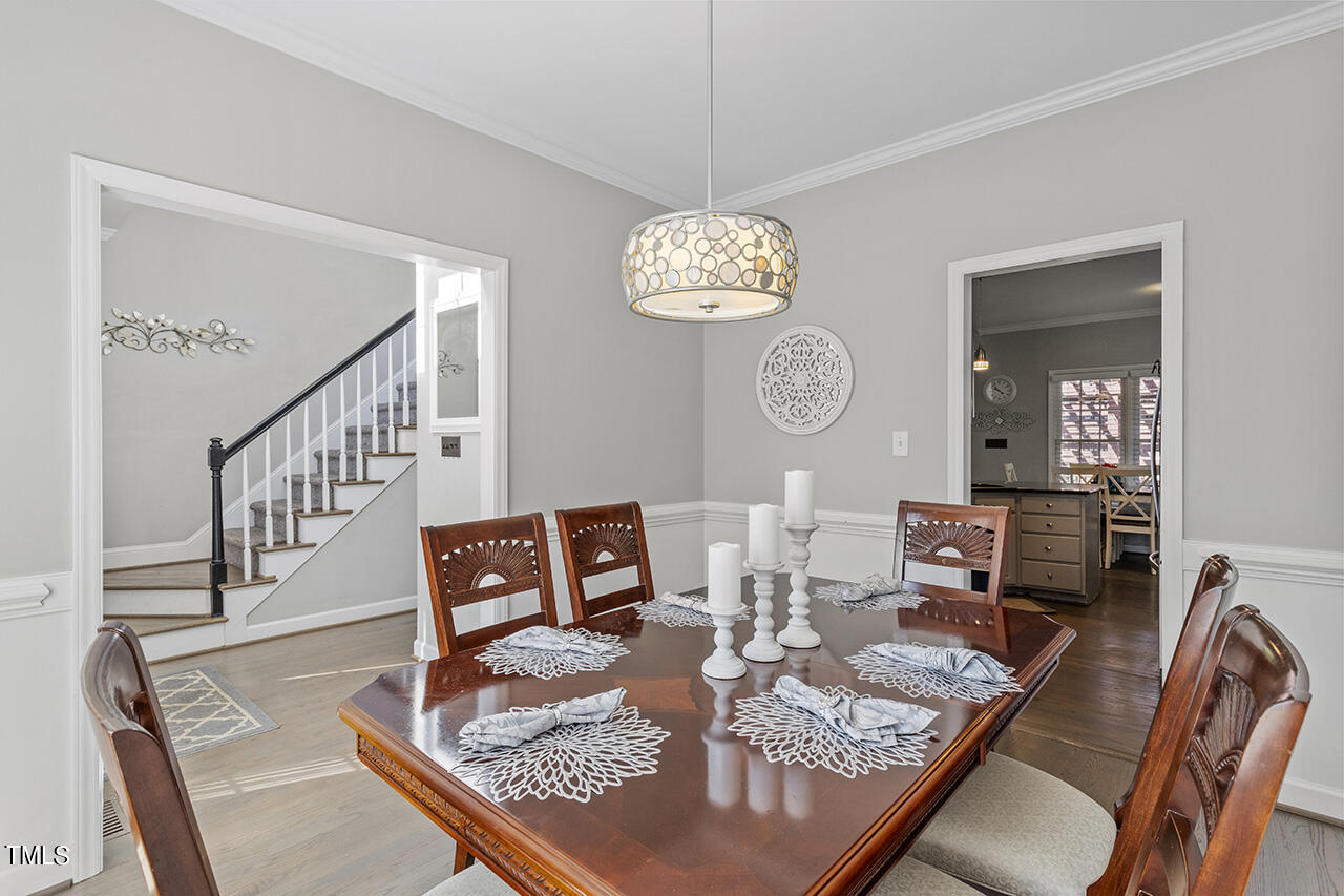 8604 Paddle Wheel Drive Raleigh, NC 27615 - Photo 5 of 33 a living room with furniture dining table a rug and a window