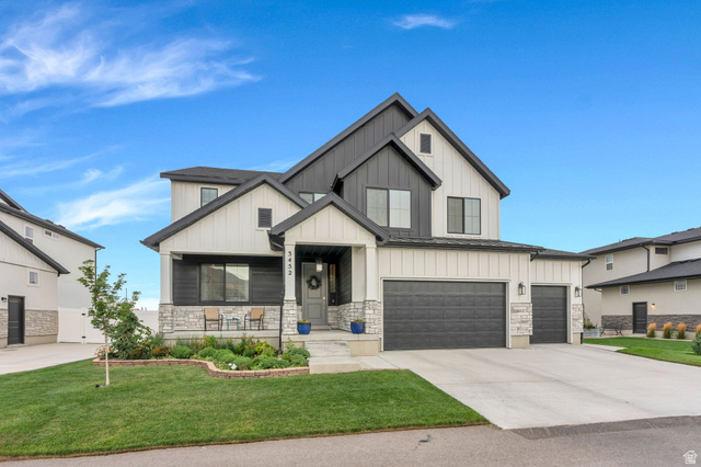 Multi-level exterior with a striking contrasting facade, stone accents, and varied rooflines